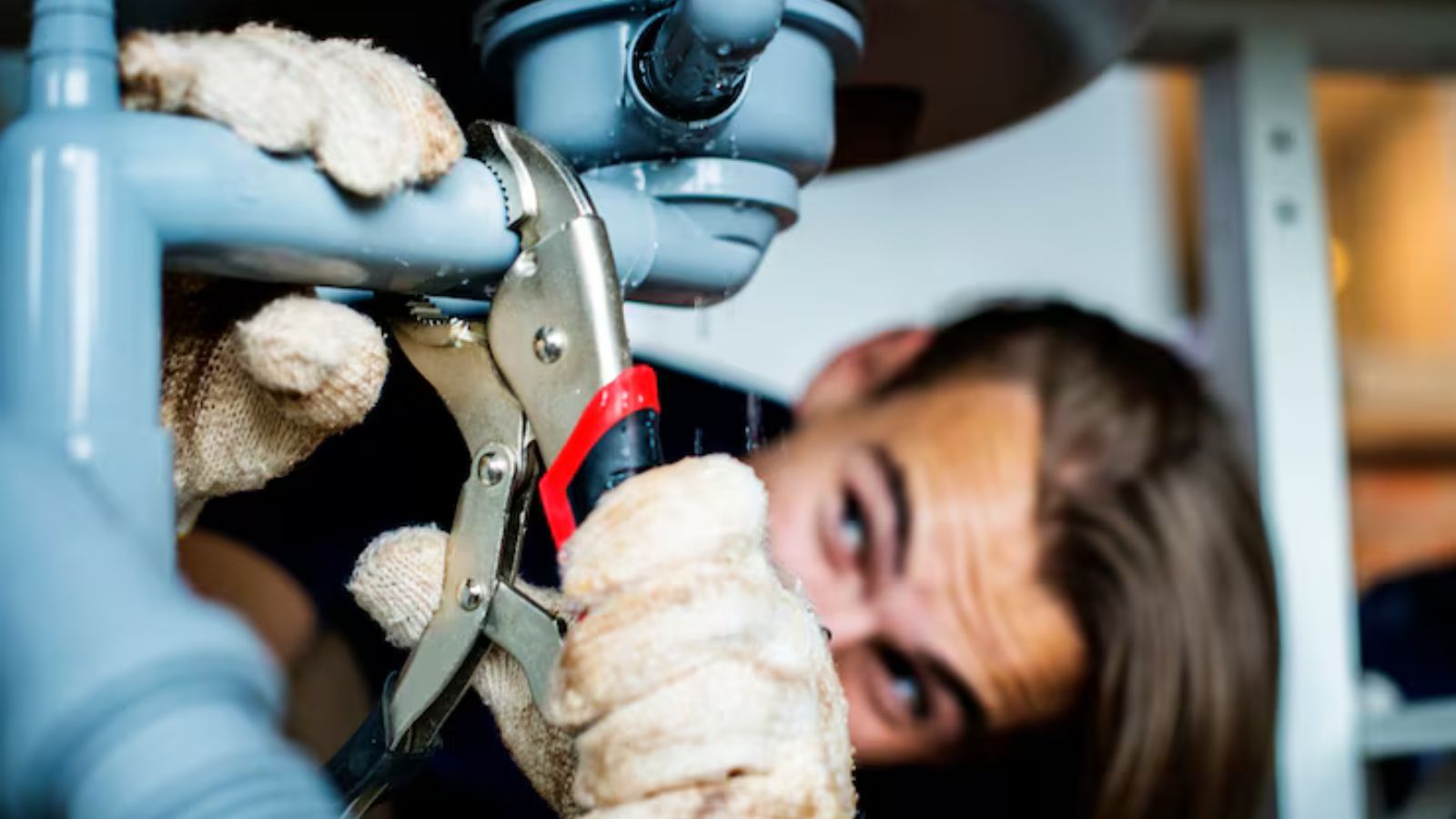 Plumber using electronic equipment to detect a hidden leak